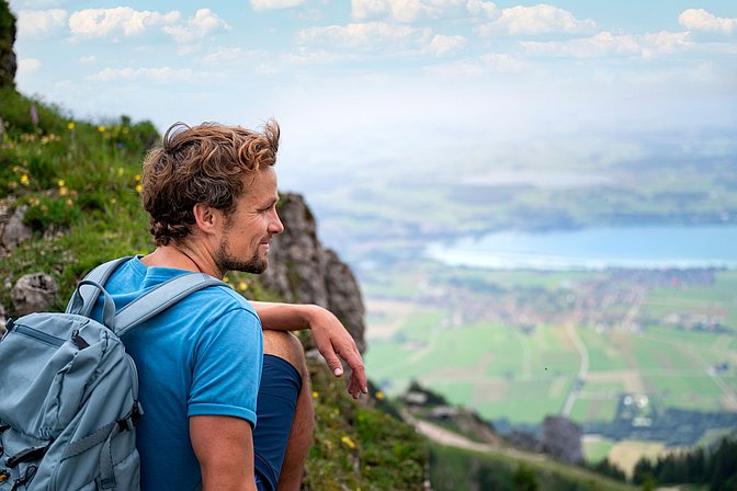 Wanderer schaut vom Berggipfel ins Tal